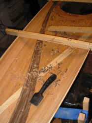 Paint scrapers work well on glue.